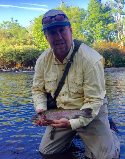 Andy Anderson, owner of Vermont Unlimited, holding a trout